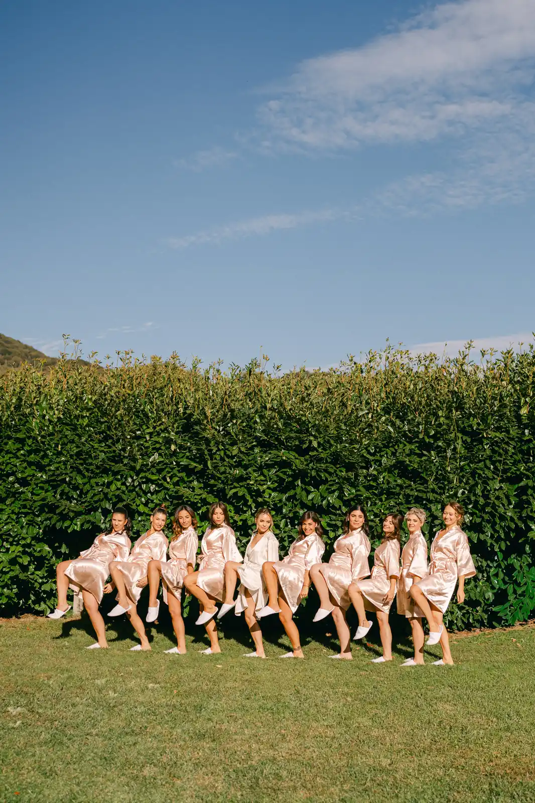 The bridesmaids sitting on the lawn before the ceremony at Parco dei Cimini