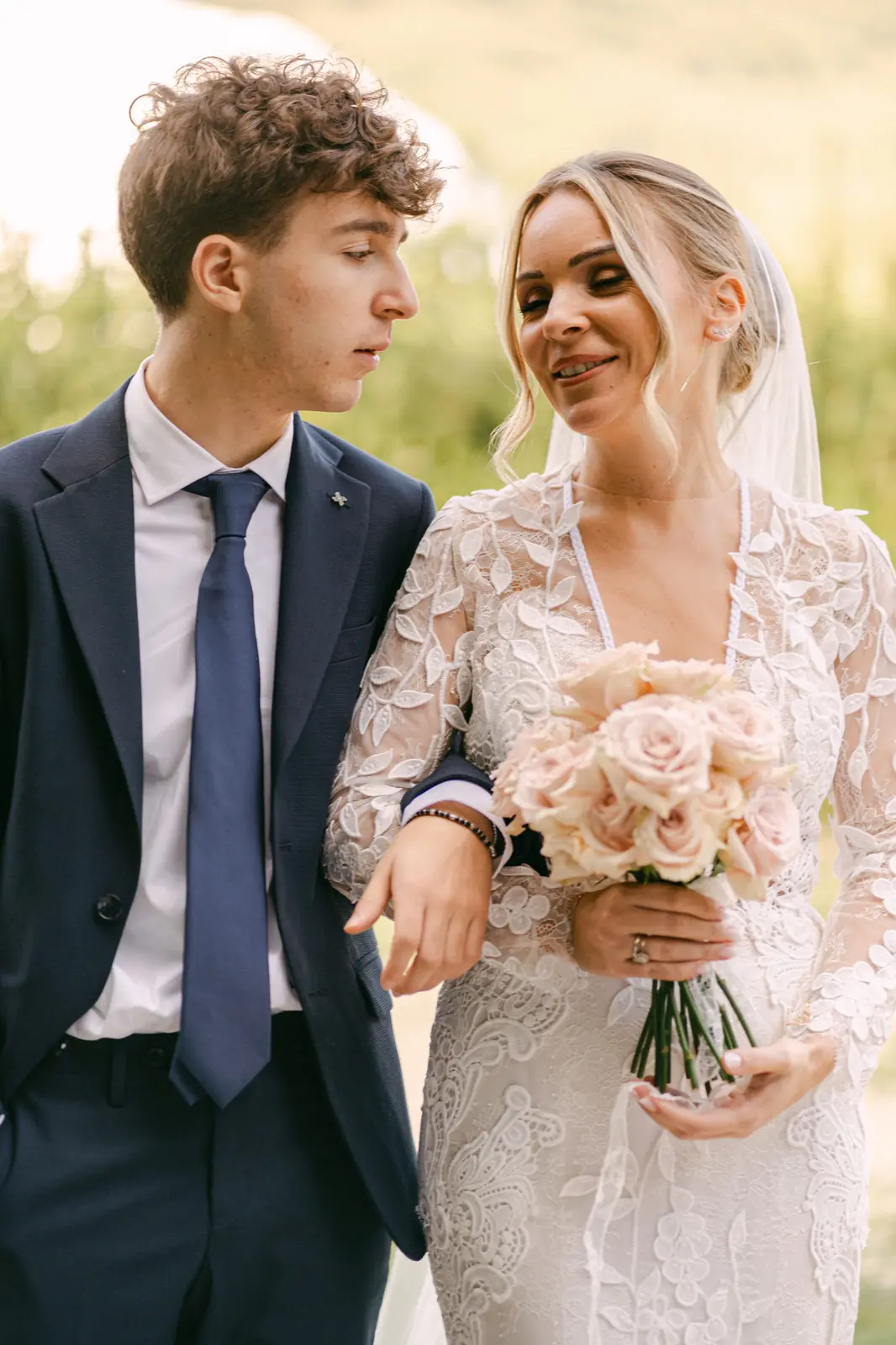 The bride with her bouquet, accompanied by a guest