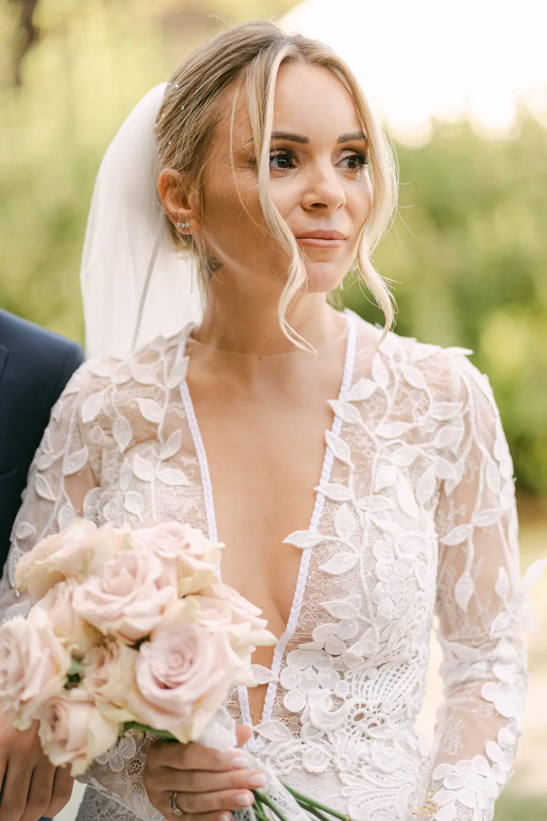 A portrait of the bride with her pale rose bouquet