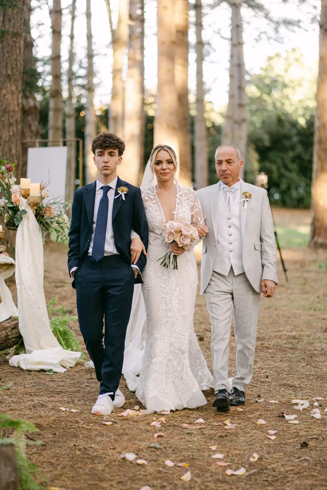 The bride entering the woods, accompanied to the ceremony