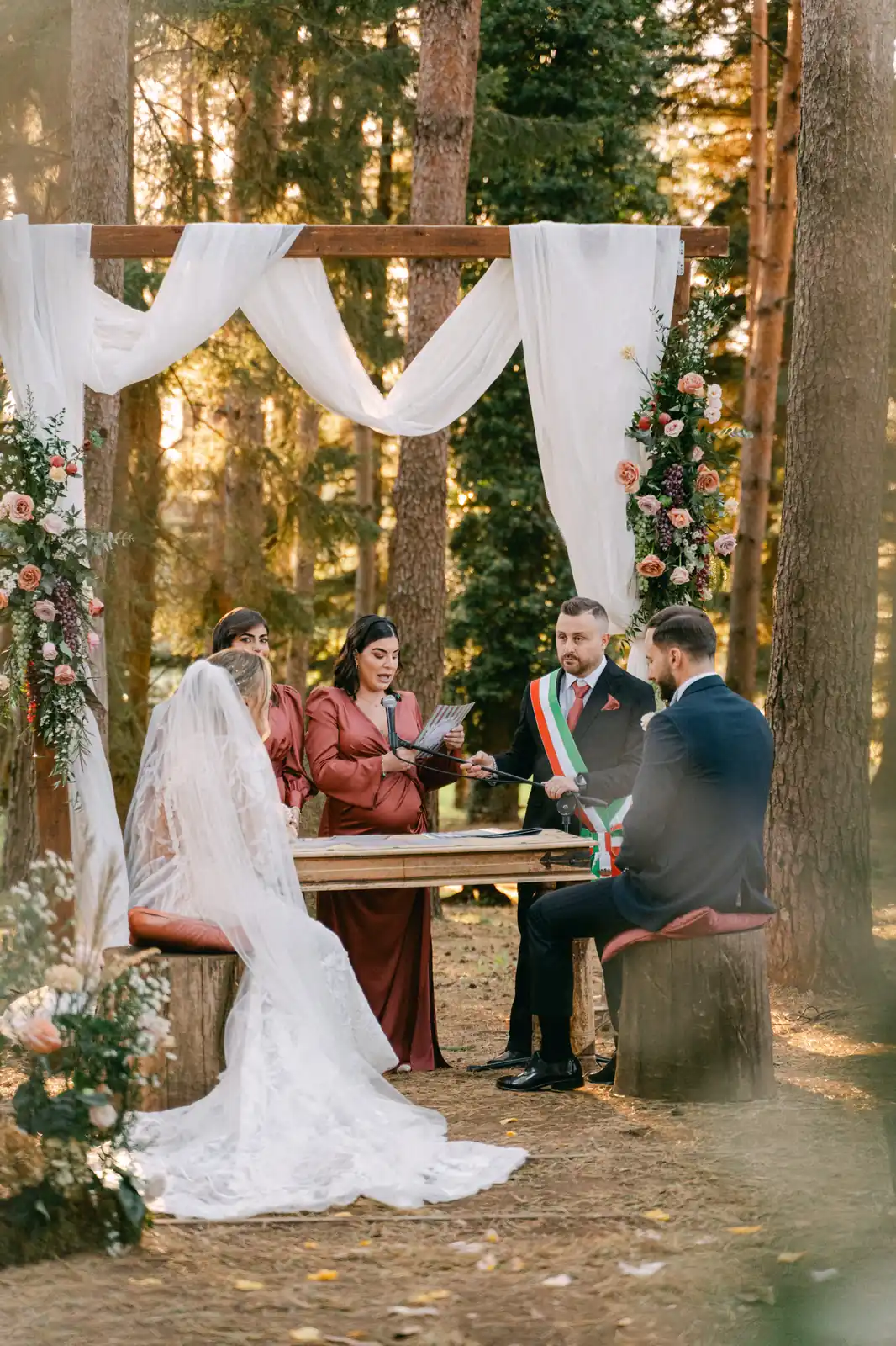 A wide view of the ceremony among the tall pines of Parco dei Cimini