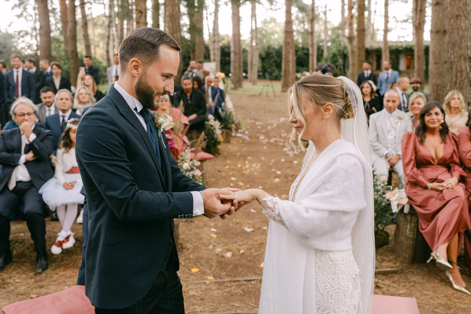The couple exchanging rings in front of the guests