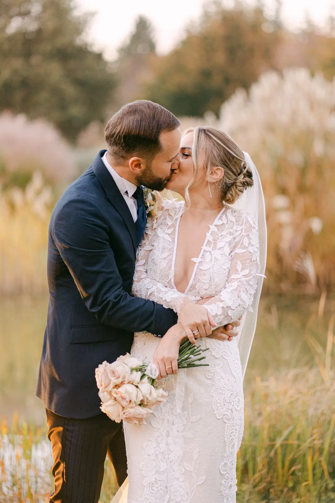 The couple kissing at sunset during their session