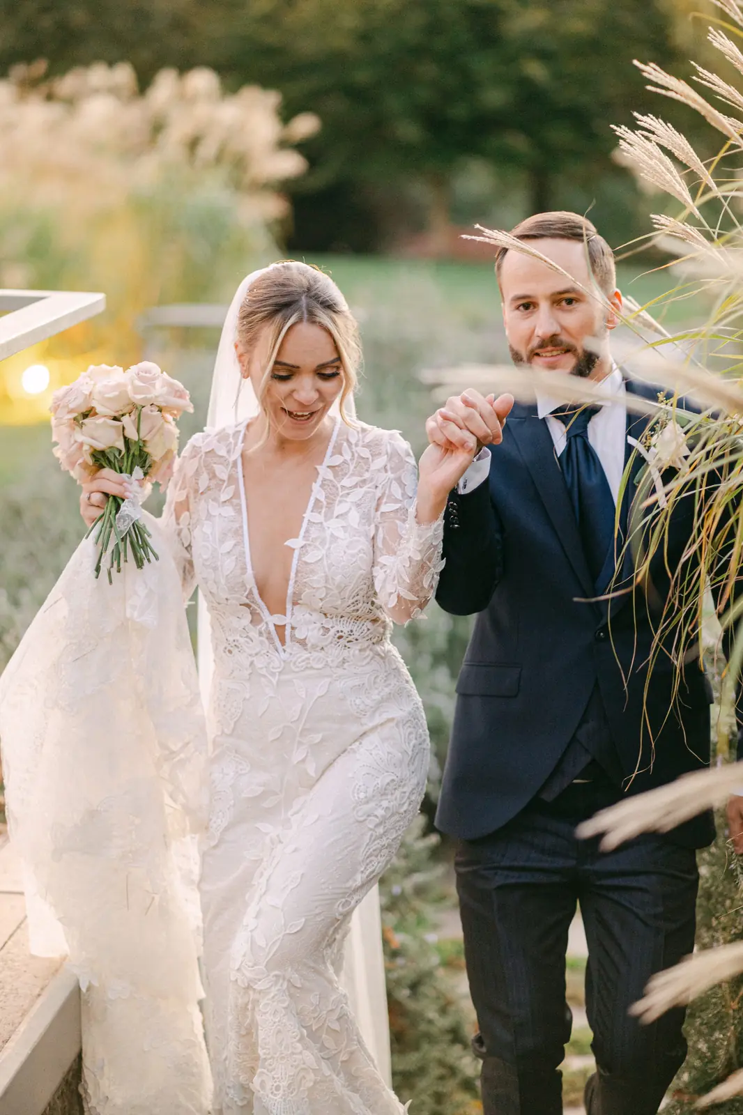 A playful portrait of the couple among the pampas at sunset