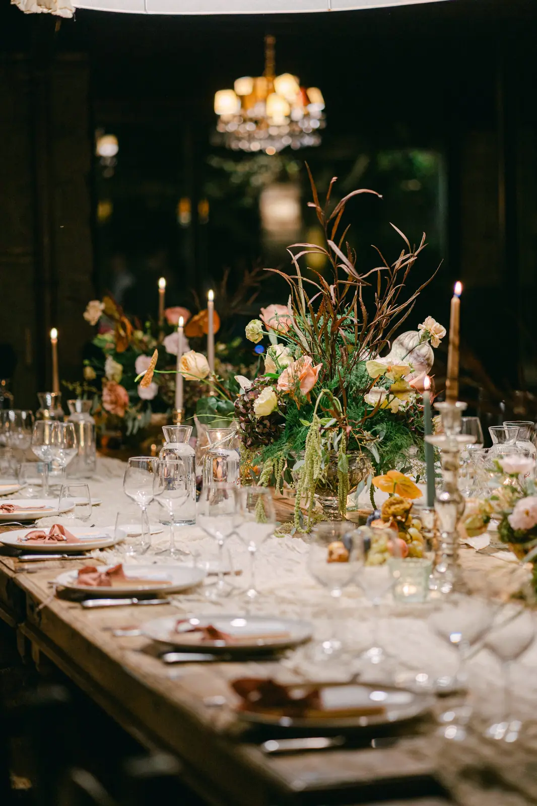 The reception table set with autumnal flowers