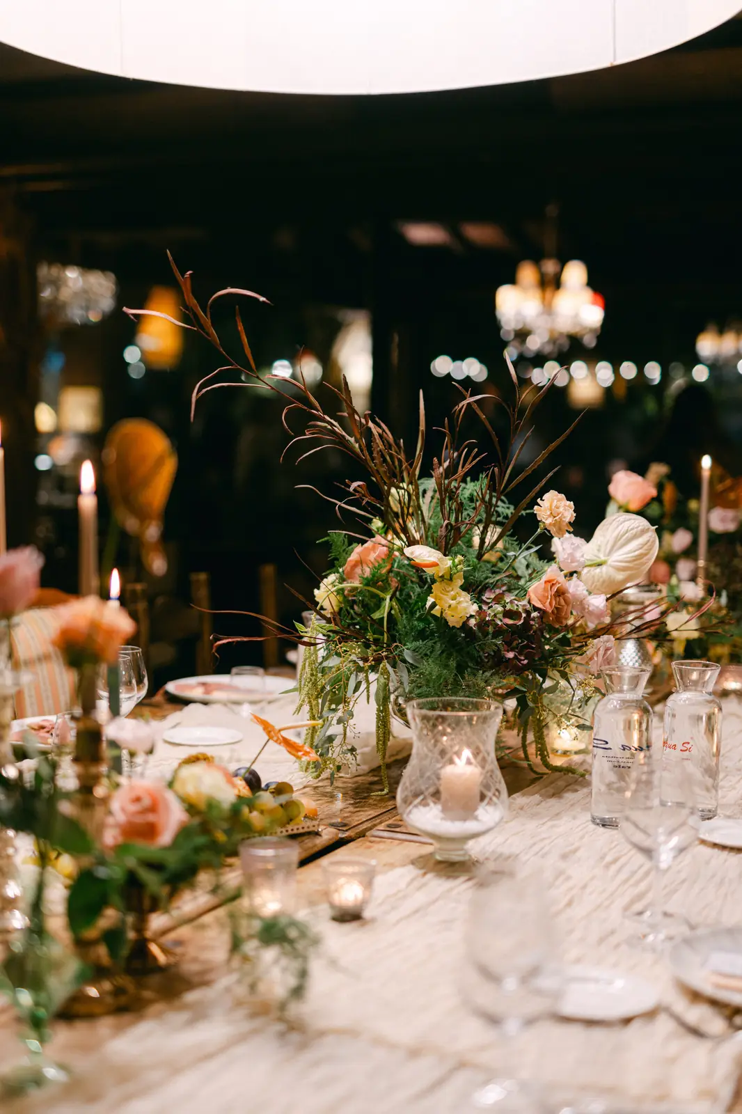 The reception table with floral centrepieces and candles