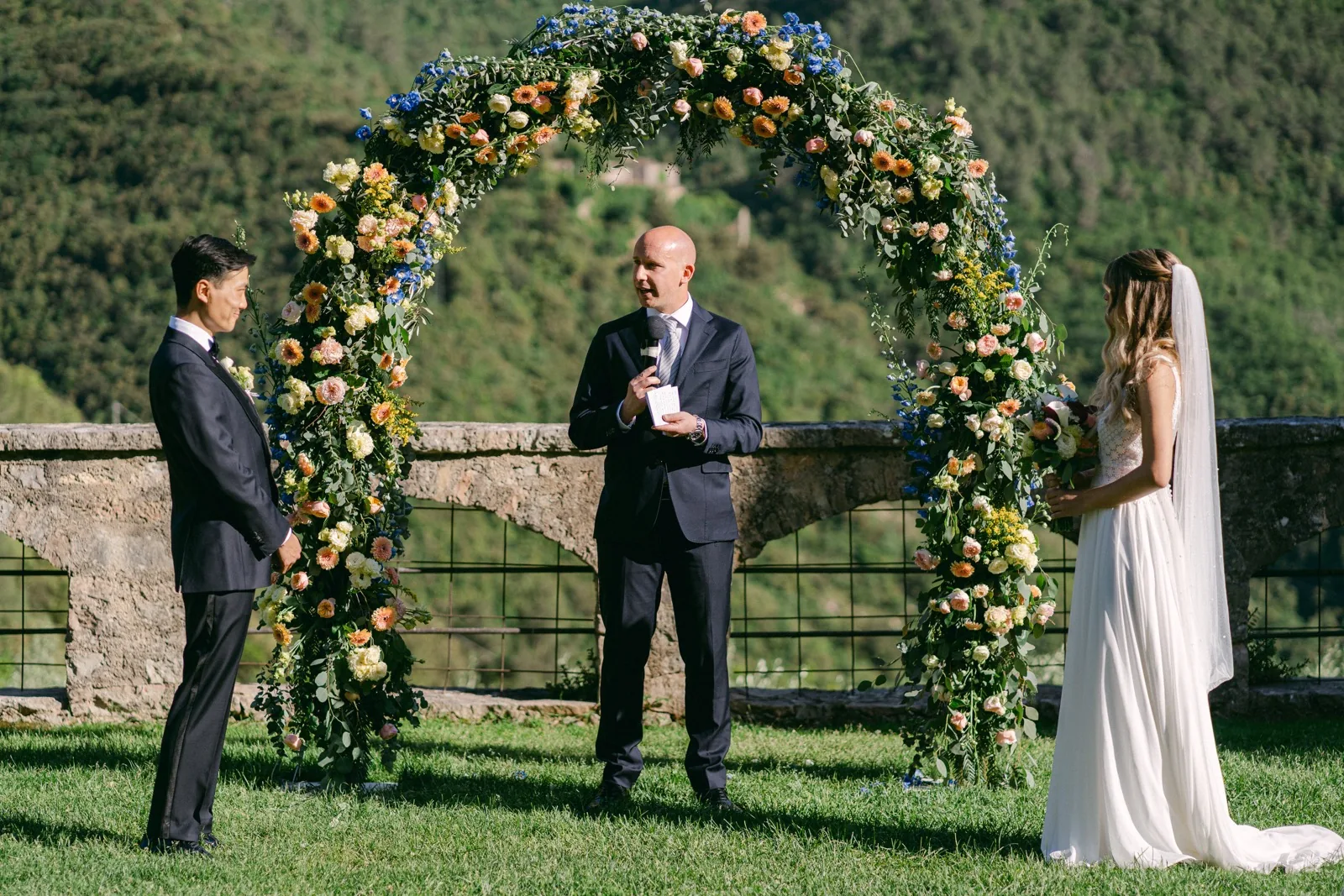 La cerimonia sotto l’arco di fiori nel giardino dell’Abbazia San Pietro in Valle, affacciato sulla Valnerina