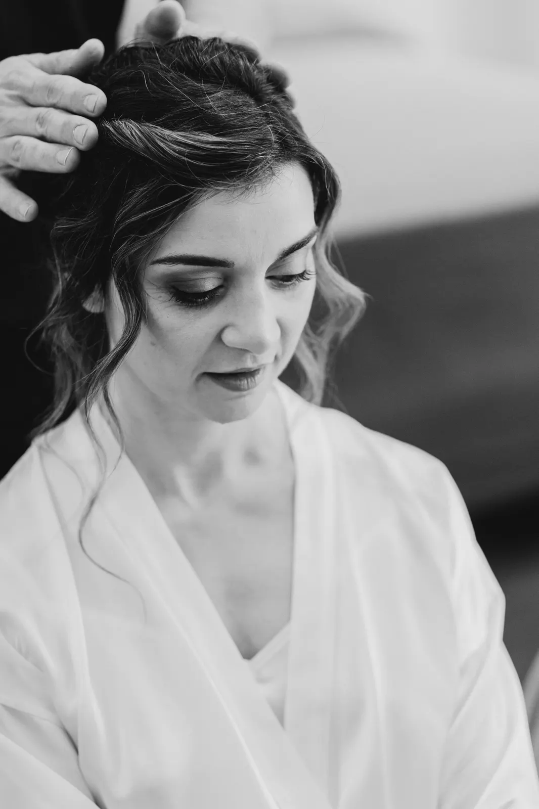 Martina in her robe while her hair is styled, in black and white