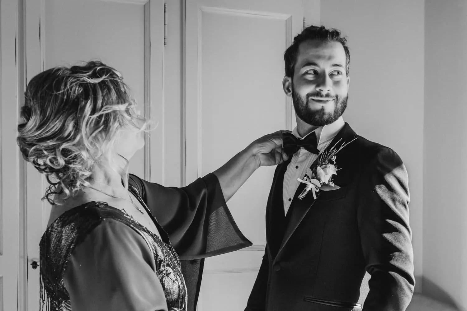 La madre appunta il fiore all'occhiello di Raffaele, in bianco e nero