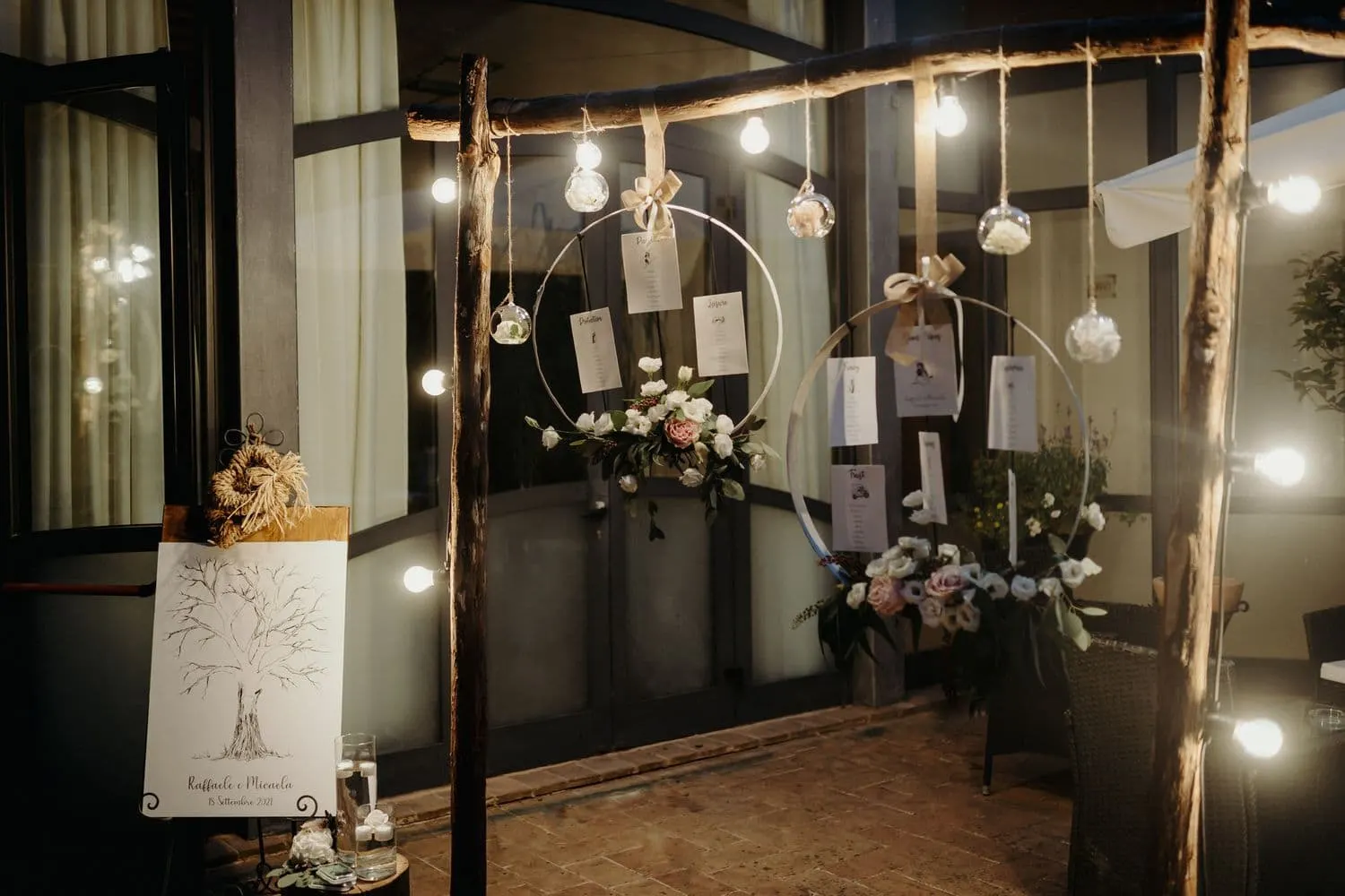 Il tableau de mariage appeso a cerchi metallici tra le lampadine