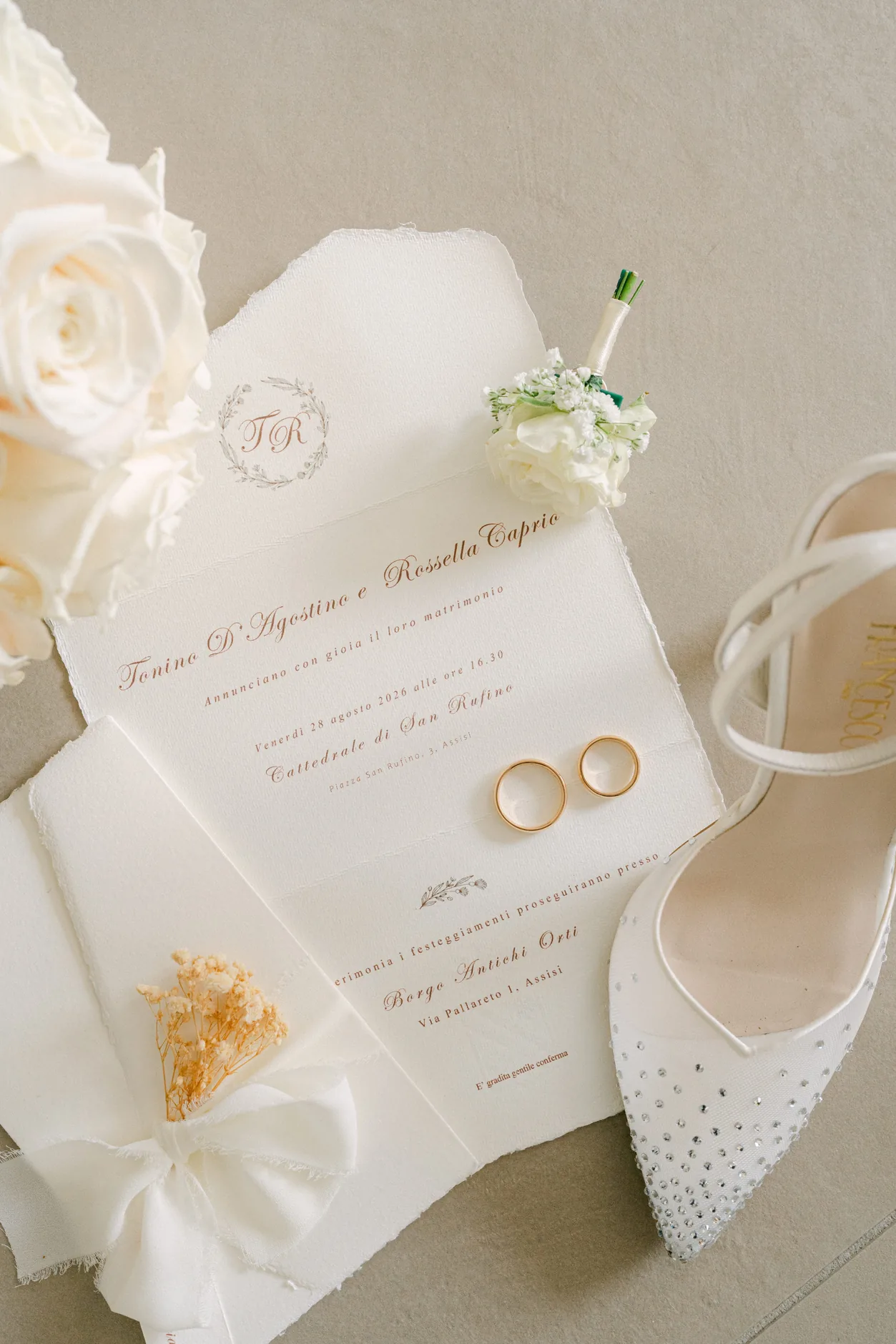 Invitation, rings, the bride's shoe and white roses: the wedding details