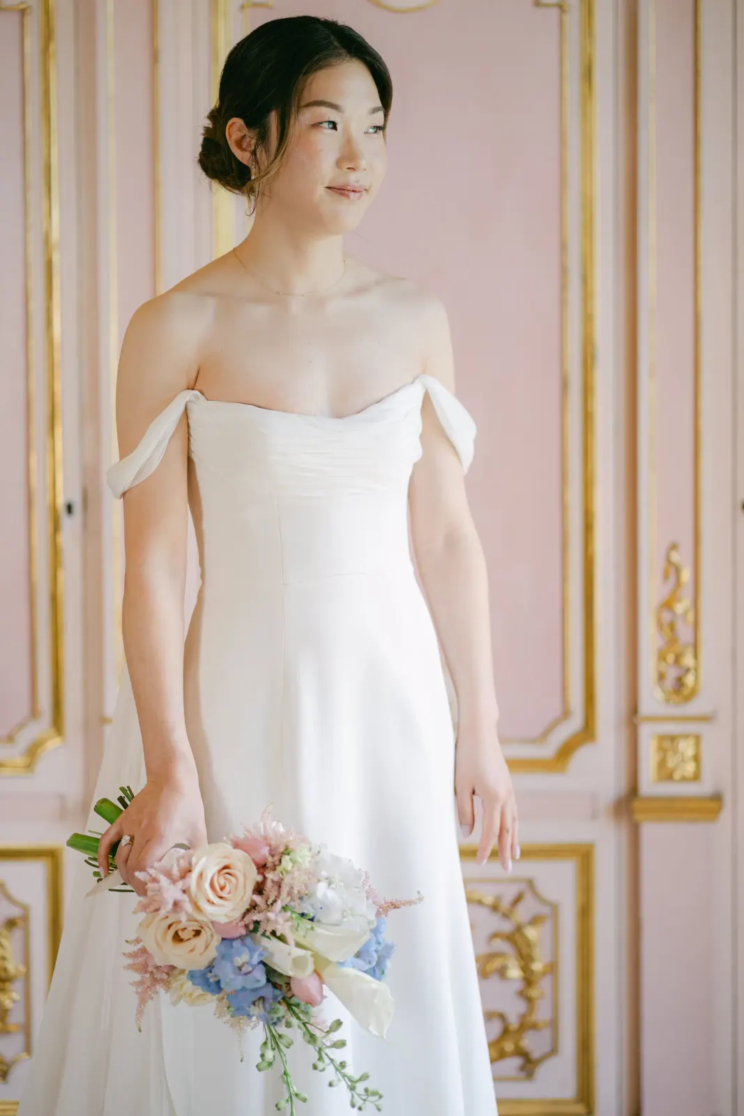Portrait of Audrey in her off-the-shoulder gown, bouquet in hand