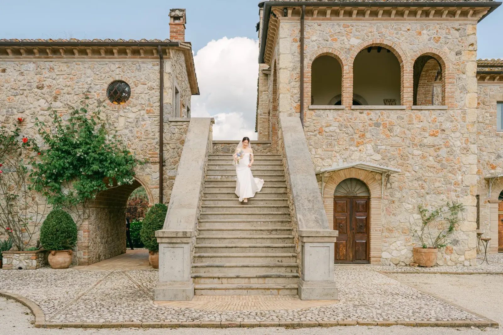 Audrey coming down the villa's great stone staircase for the first look