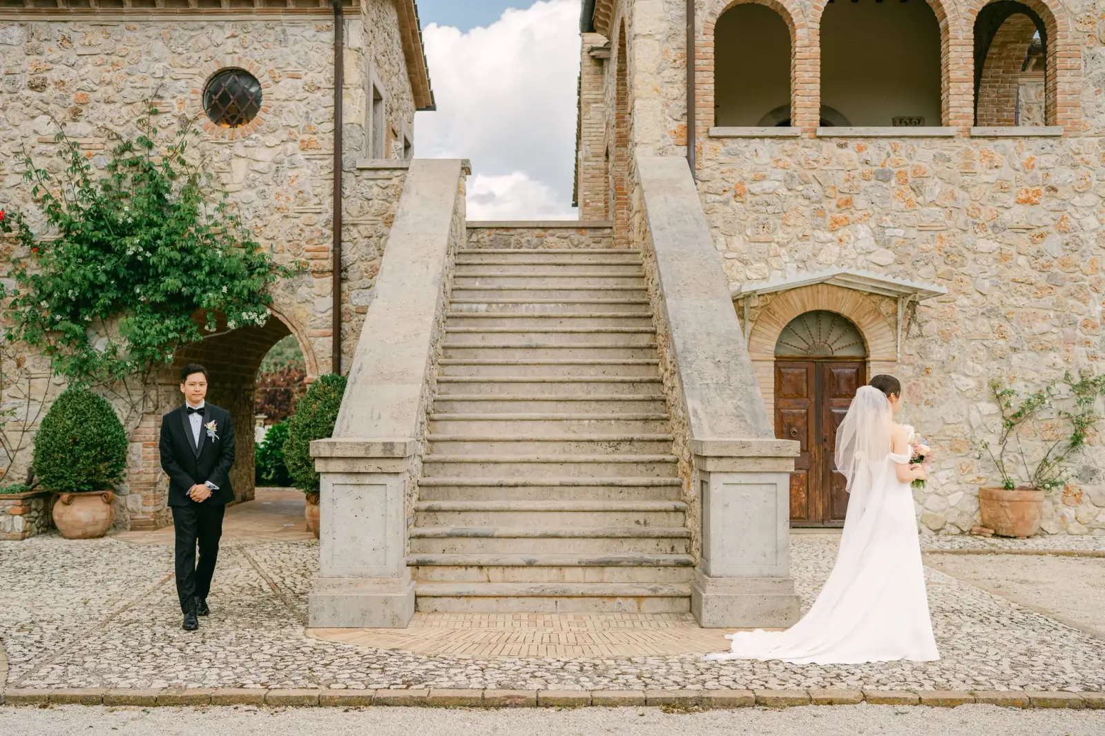 James waiting at the foot of the staircase as Audrey arrives behind him