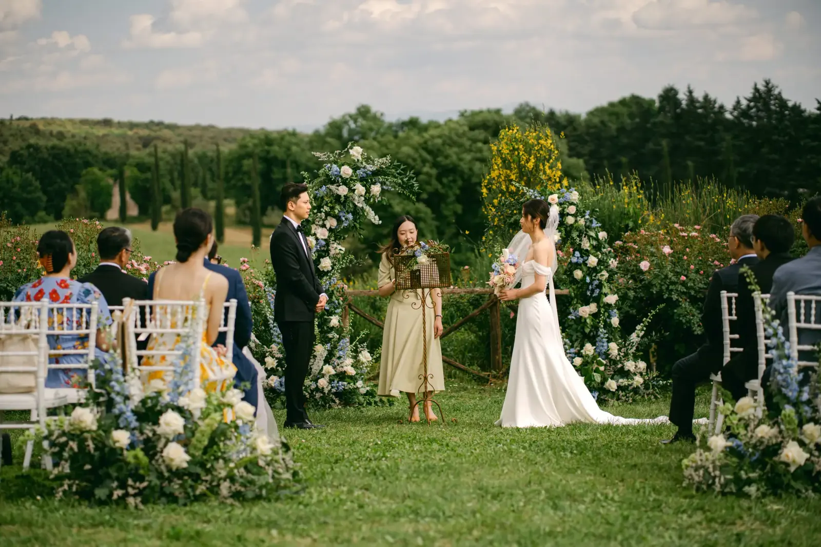 Wide view of the ceremony on the lawn, with the guests seated