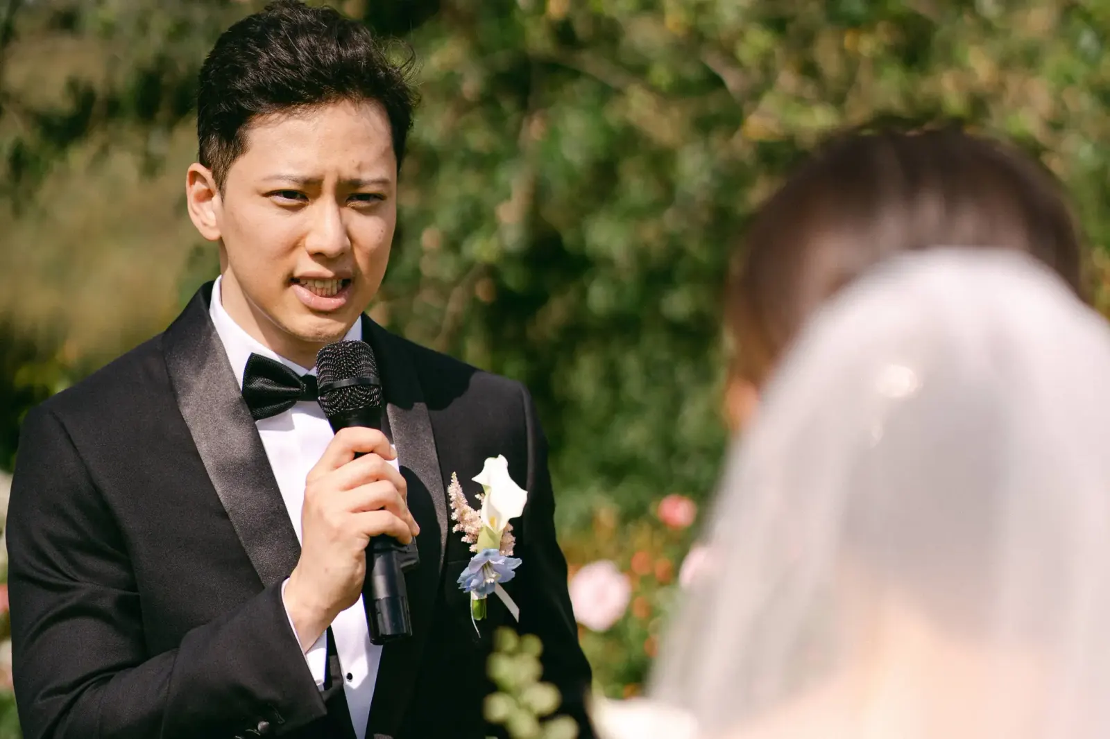 James reading his vows into the microphone, moved