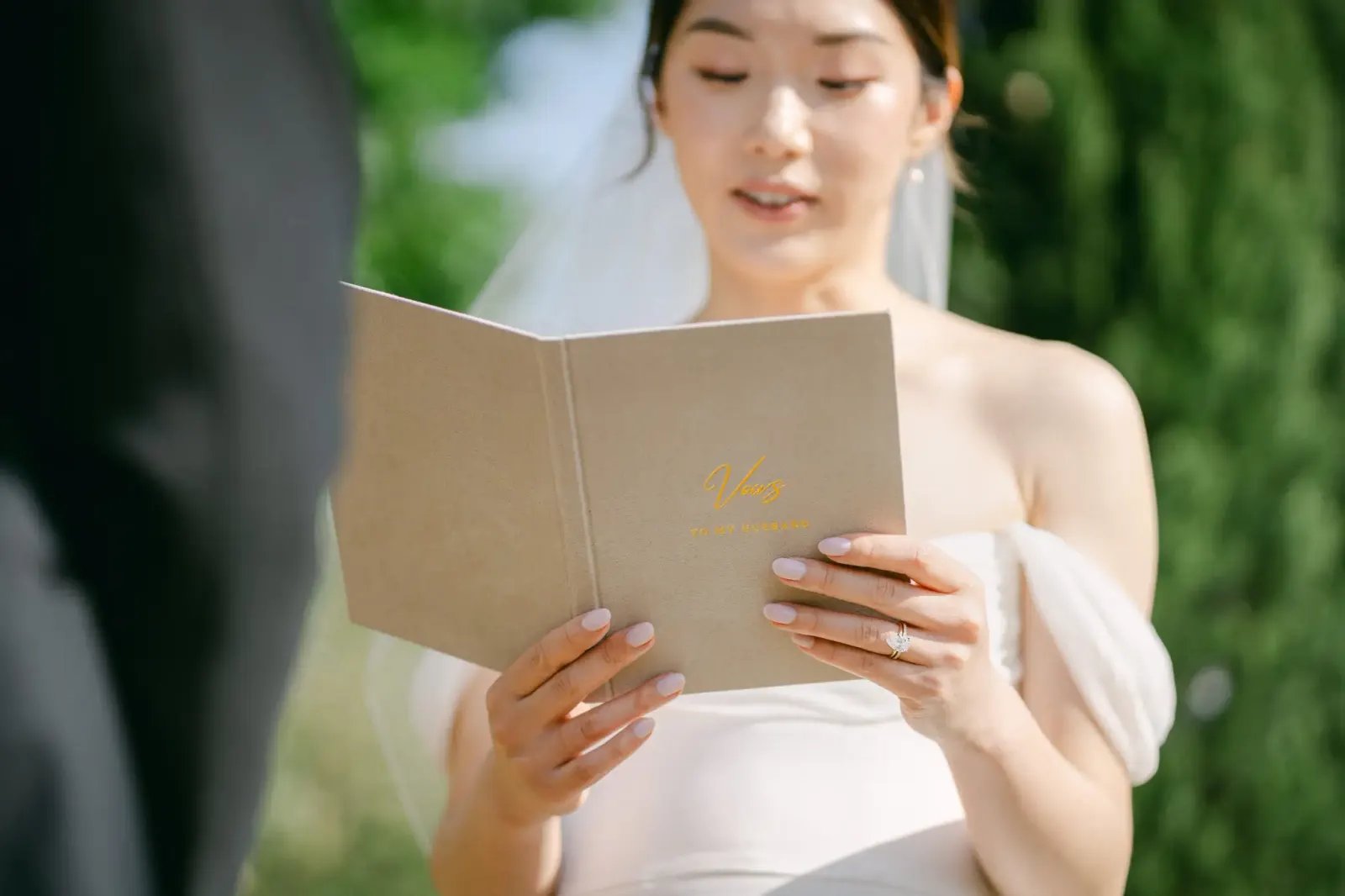 Audrey reading her vows from a notebook