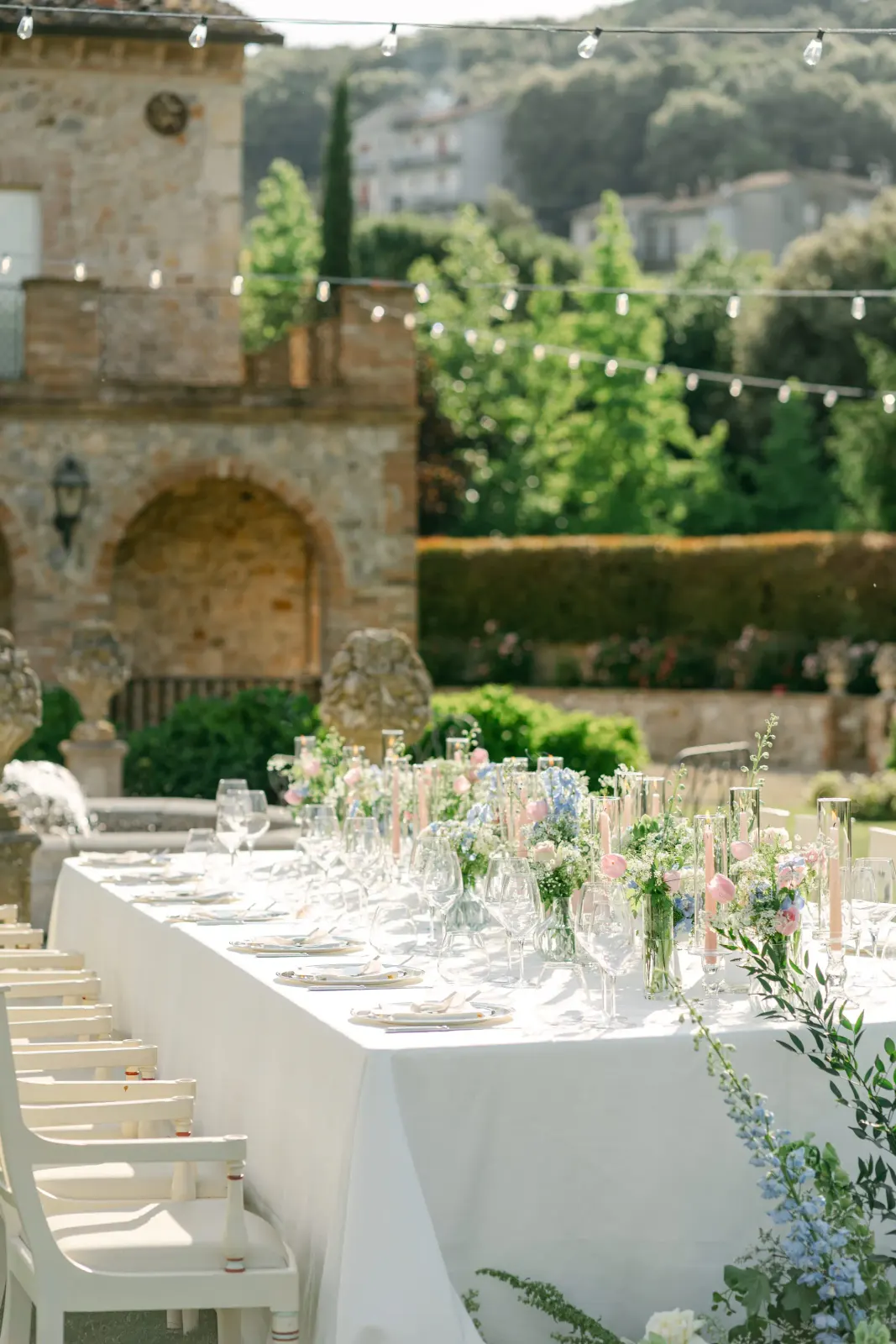The long table laid in the Italian garden, with flowers and glassware