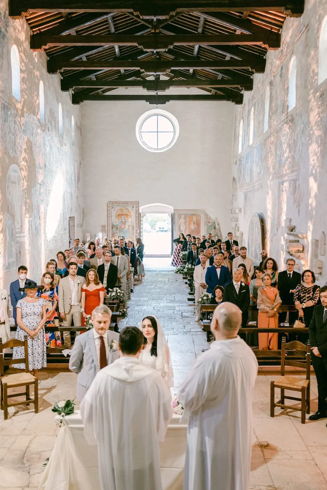 The nave seen from the altar, with the couple before the celebrants and the guests standing