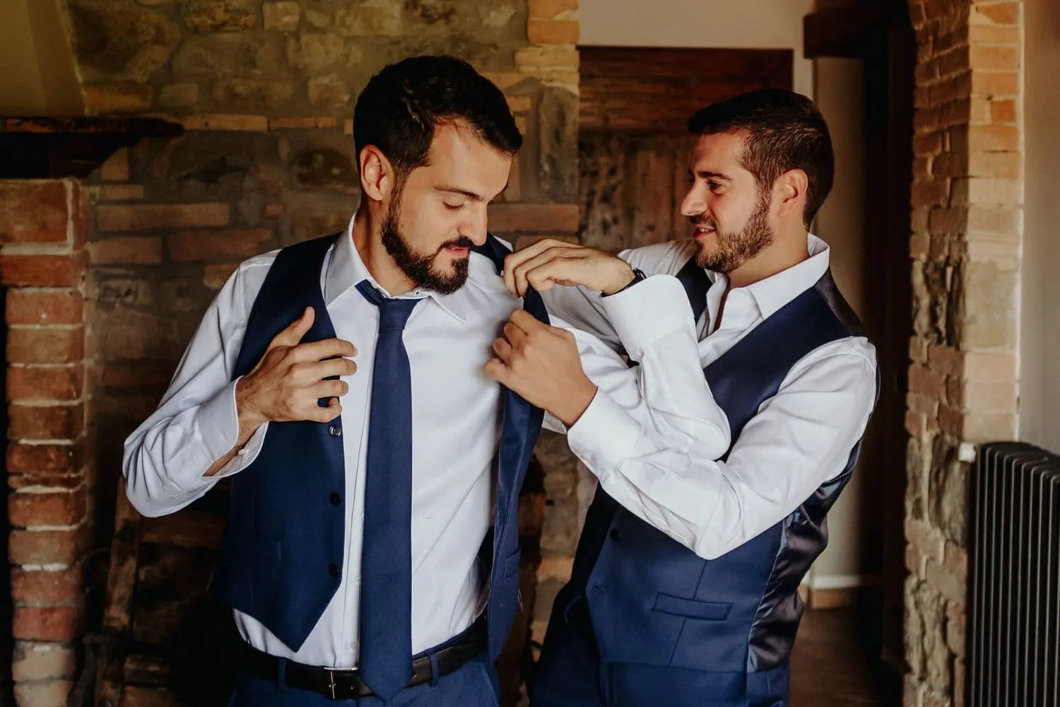 Francesco being helped with his collar and tie before the ceremony