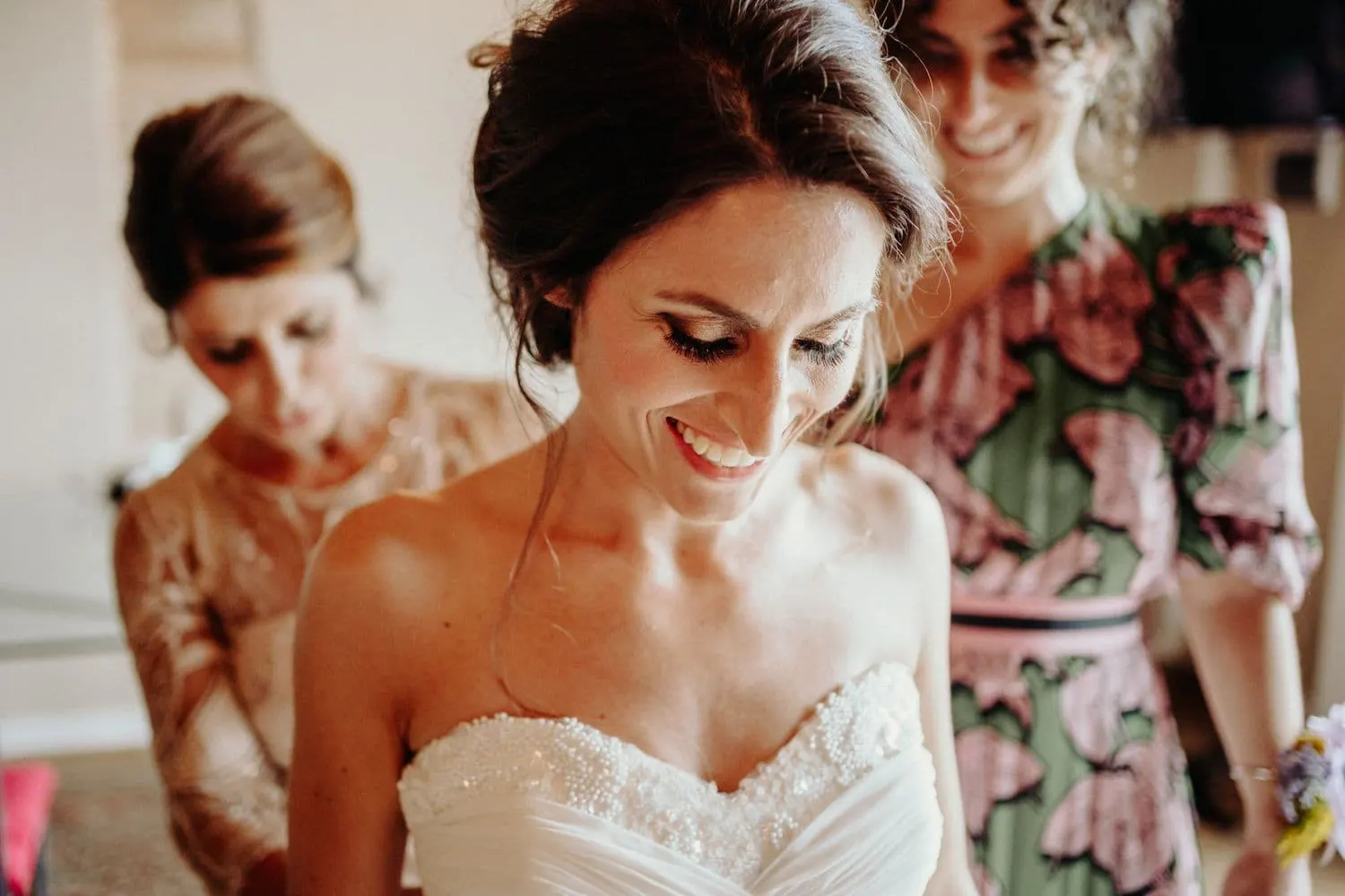 Giulia smiling with her eyes lowered as she is dressed