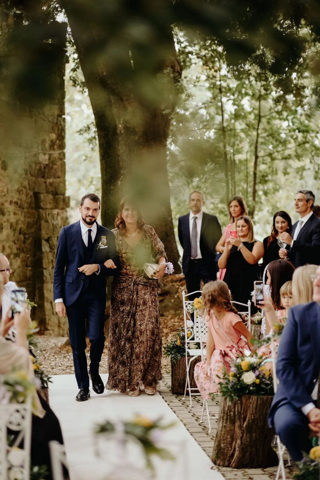 Francesco arriving at the ceremony, walked down the white aisle runner among the guests