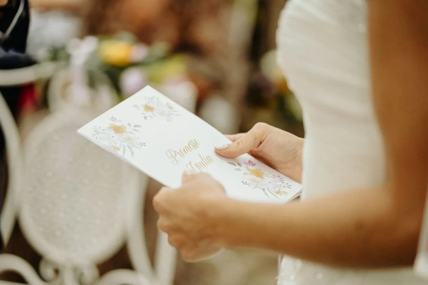 The vow booklet in the bride's hands
