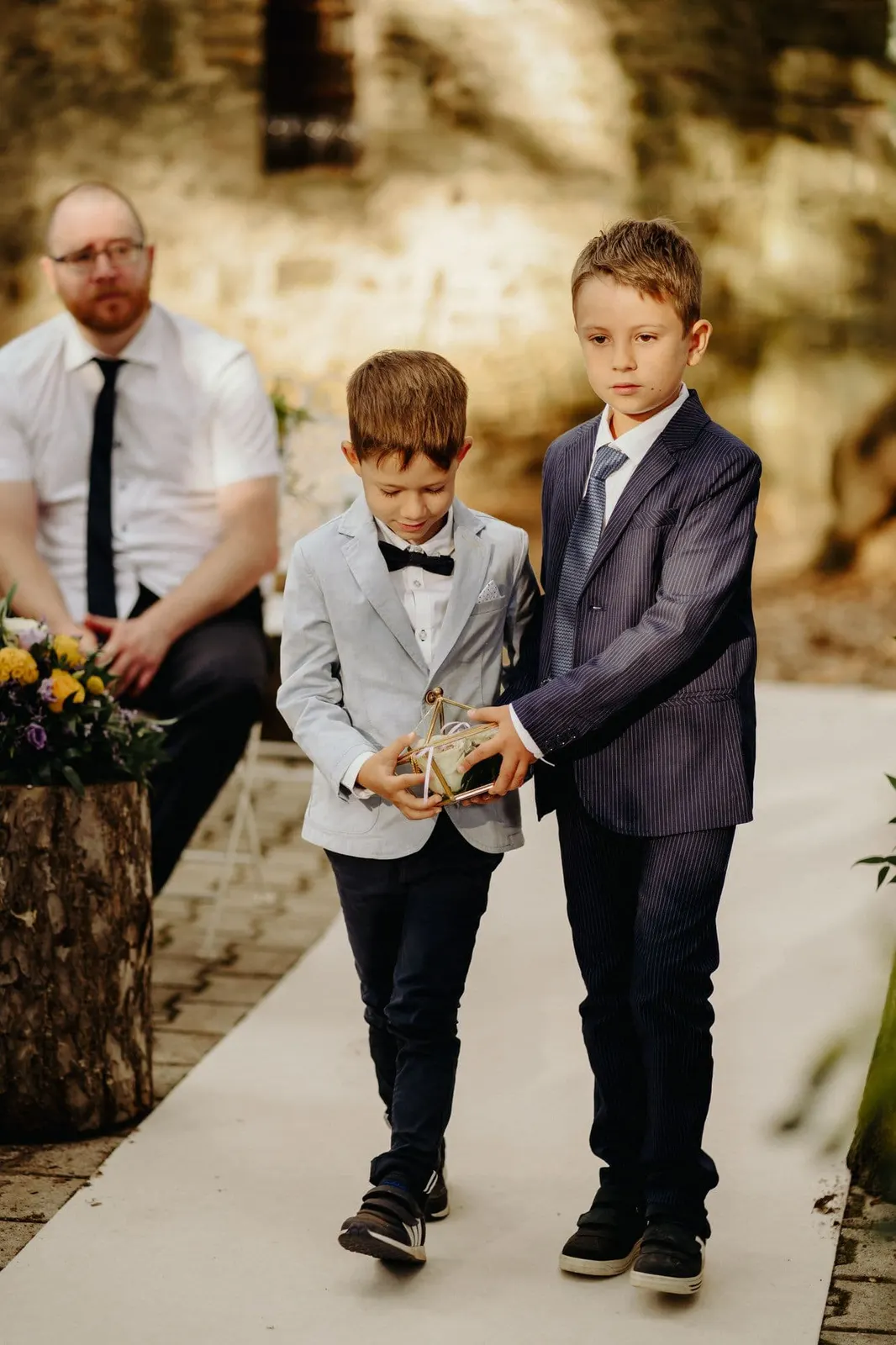 Two boys carrying the rings down the aisle