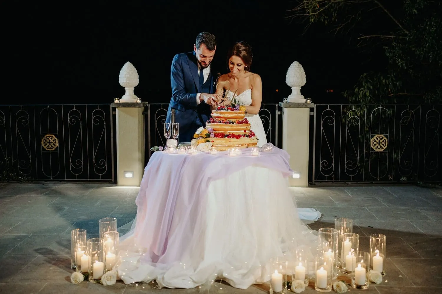 Cutting the cake on the terrace, among the candles