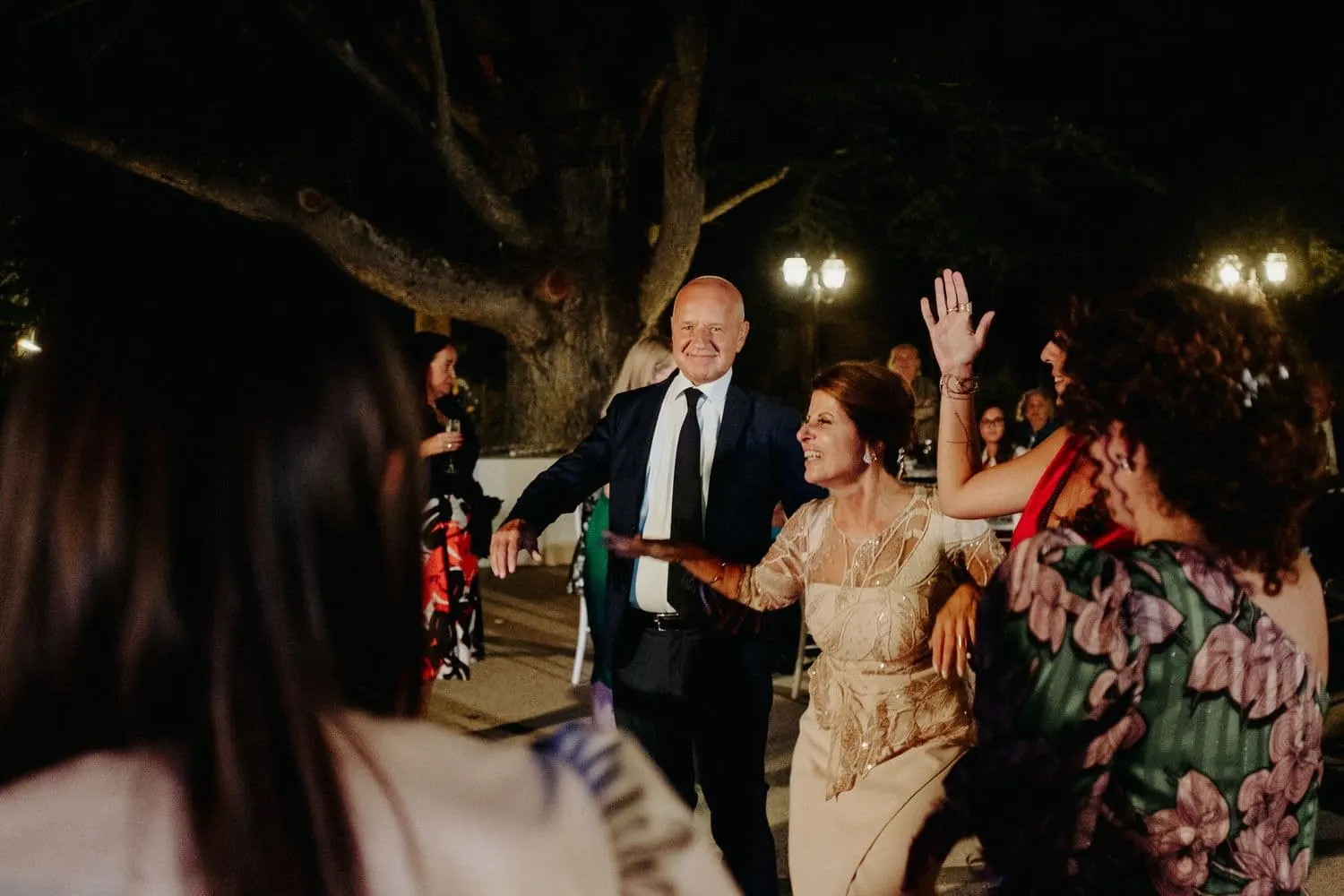 Guests dancing outdoors during the party