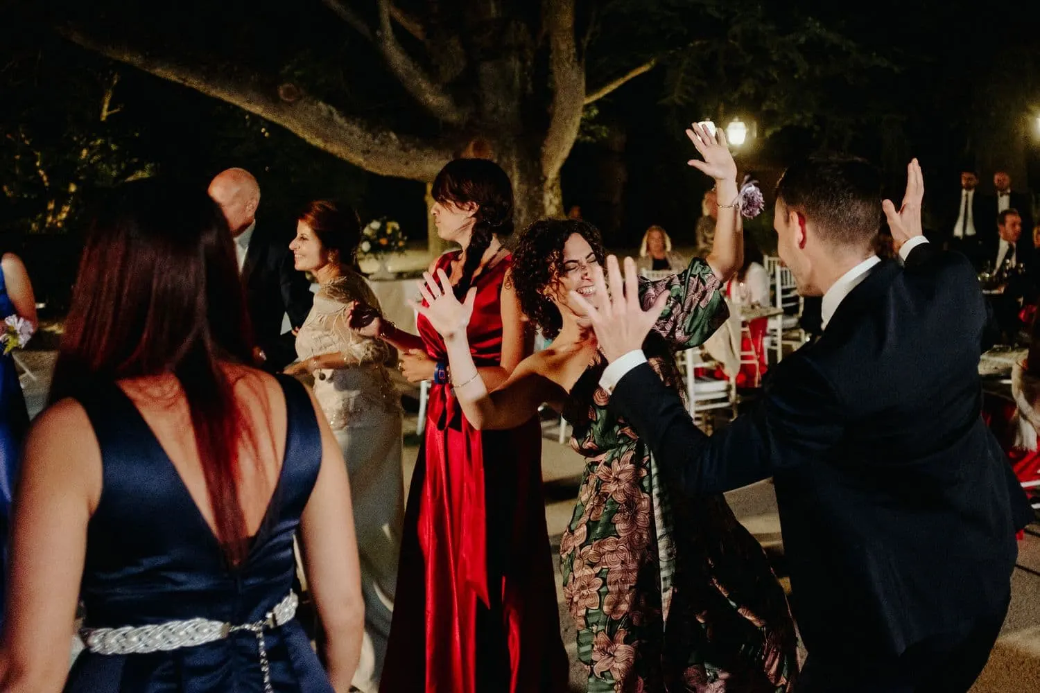 The party on the dance floor under the trees, in the evening